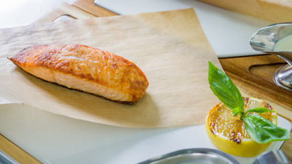 Grilled salmon steak with caviar sauce before serving