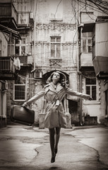 girl on the yard with suitcase in Odessa.. Image in black and white color style
