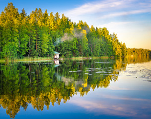 Tampere Finland lake reflections on water with little house on the water, beautiful sky with many colors and trees