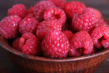 Fresh raspberries on a wooden background.