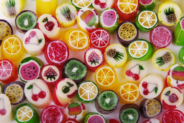  Multicolored caramel with a taste of different fruits on a white background.