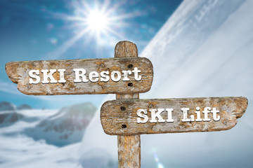 Directions on the signpost to the ski resort and the ski lift.