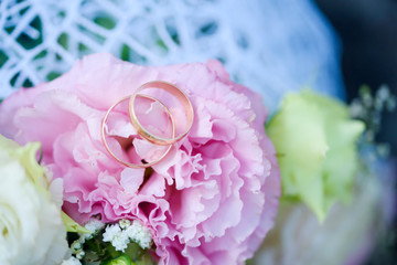 Wedding day for the newlyweds. Wedding attributes of the newlyweds. Wedding rings. Wedding bridal bouquet.