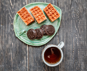 Flat top view of tea ceremony with cups of tea and sweet cookies
