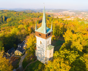Aerial view to The Bolfanek viewtower with the St. Wolfgang´s cemetery chapel. Near a  marvelous village Chudenice from 12th century. Czech landmarks from above. Autumn in Central Europe.