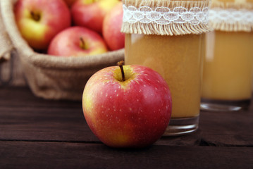 Fresh juice from red apples in a glass beaker.