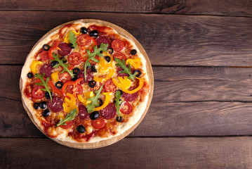 Italian pizza on a wooden background.