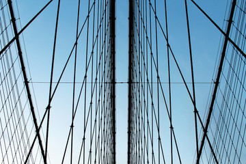 Fototapeta na wymiar Metal bridge wires tie rods against blue sky