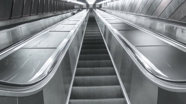 Empty escalator in dark atmosphere. Stockholm's subway, brick style wall and modern, abstract footage with stairway. 