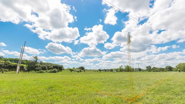 Sports Field Timelapse with Game Play. a timelapse at the corner of a sports field while people play a hurling game