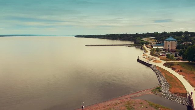 Aerial Fly Along Lake Coastline. an aerial view moving down the coastline over the lake. Slow motion