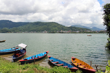 Boats around Phewa Lake and hills in Pokhara, a popular tourist destination