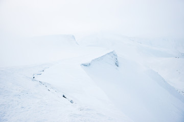 Mountain in snow with fog. Winter landscape