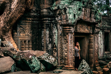 Adventure travel in the ancient jungle ruins of Angkor Cambodia  - obrazy, fototapety, plakaty