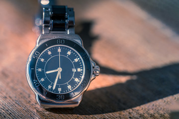Classic wrist watch on wood