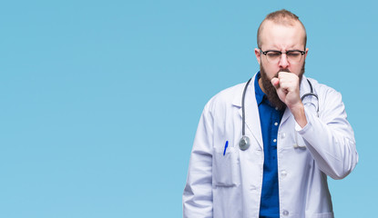 Young caucasian doctor man wearing medical white coat over isolated background feeling unwell and...