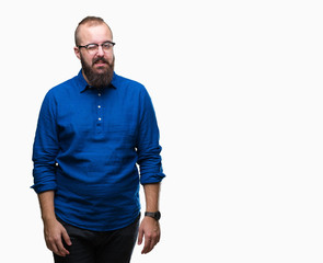 Fototapeta premium Young caucasian hipster man wearing glasses over isolated background winking looking at the camera with sexy expression, cheerful and happy face.