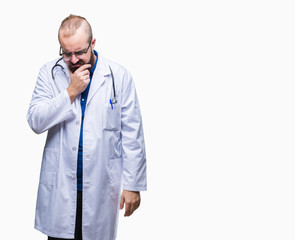 Young caucasian doctor man wearing medical white coat over isolated background thinking looking tired and bored with depression problems with crossed arms.
