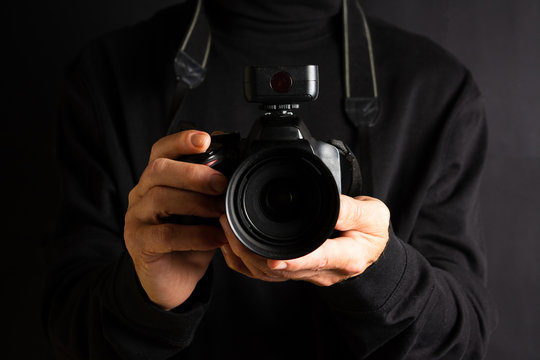 Person holding a camera close up