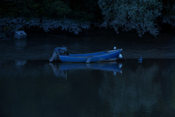 A lone boat on the River Dee in Chester, UK