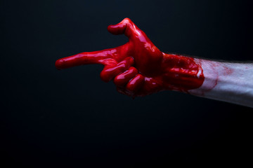 Bloody hand against a dark background. halloween horror concept