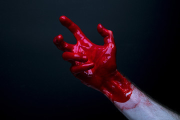 Bloody hand against a dark background. halloween horror concept