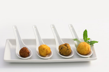 Fried meat balls in a white plate on white background