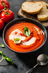 Creamy tomato soup served in bowl