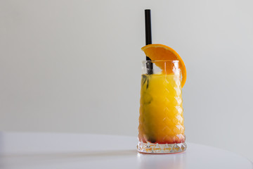 Tequila sunrise cocktail isolated on a gray background, horizontal