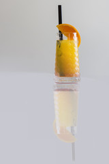 Tequila sunrise cocktail isolated on a gray background, vertical