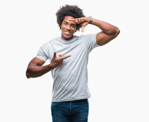 Afro american man over isolated background smiling making frame with hands and fingers with happy face. Creativity and photography concept.