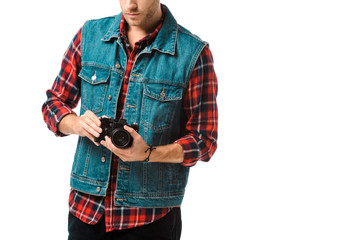 partial view of hipster male photographer in denim vest and checkered shirt shooting on camera isolated on white