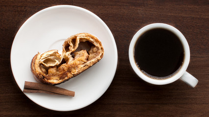 Breakfast with pie and cup of coffee on wooden table