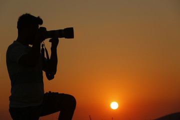  A PHOTOGRAPHER  AT SUNSET