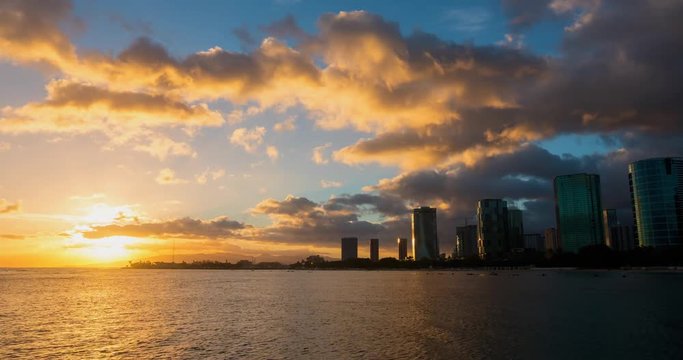 Honolulu City Timelapse at Sunset. a dramatic timelapse of waikiki beach at sunset in honolulu