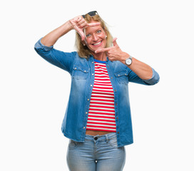 Middle age blonde woman over isolated background smiling making frame with hands and fingers with happy face. Creativity and photography concept.