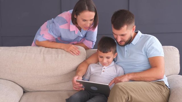 Young happy family with tablet