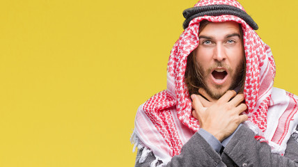 Portrait of man in keffiyeh against yellow background