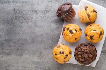 Homemade chocolate muffins on the vintage background.