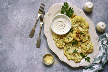 Oven baked cauliflower with cream garlic sauce.Top view with copy space.