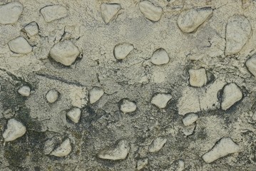 gray texture of small stones in a concrete wall