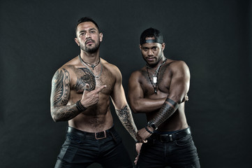 Sexy is attitude. Muscular men with fashionable tattoo style. Sexy men with muscular torso. Brutal...