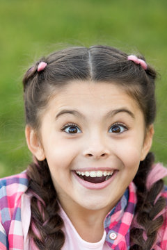 Cute surprised girl with smile on her face. Expression of happiness. Moment of unexpectancy. Looking forward to present. Beautiful young face. Bright emotion on lady face