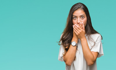 Young beautiful arab woman over isolated background shocked covering mouth with hands for mistake. Secret concept.