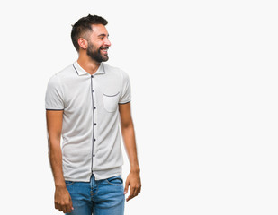 Fototapeta premium Adult hispanic man over isolated background looking away to side with smile on face, natural expression. Laughing confident.