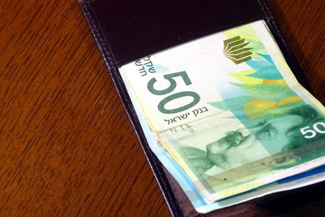 50 Israeli shekels in a leather wallet