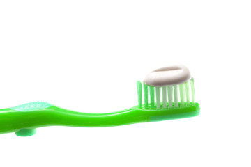 Simple Toothbrush on a White Background with Toothpaste Applied to the Bristles