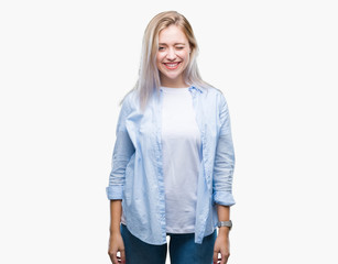 Young blonde woman over isolated background winking looking at the camera with sexy expression,...