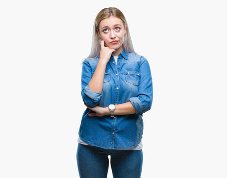 Young blonde woman over isolated background with hand on chin thinking about question, pensive expression. Smiling with thoughtful face. Doubt concept.