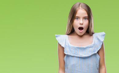Young beautiful girl over isolated background afraid and shocked with surprise expression, fear and...